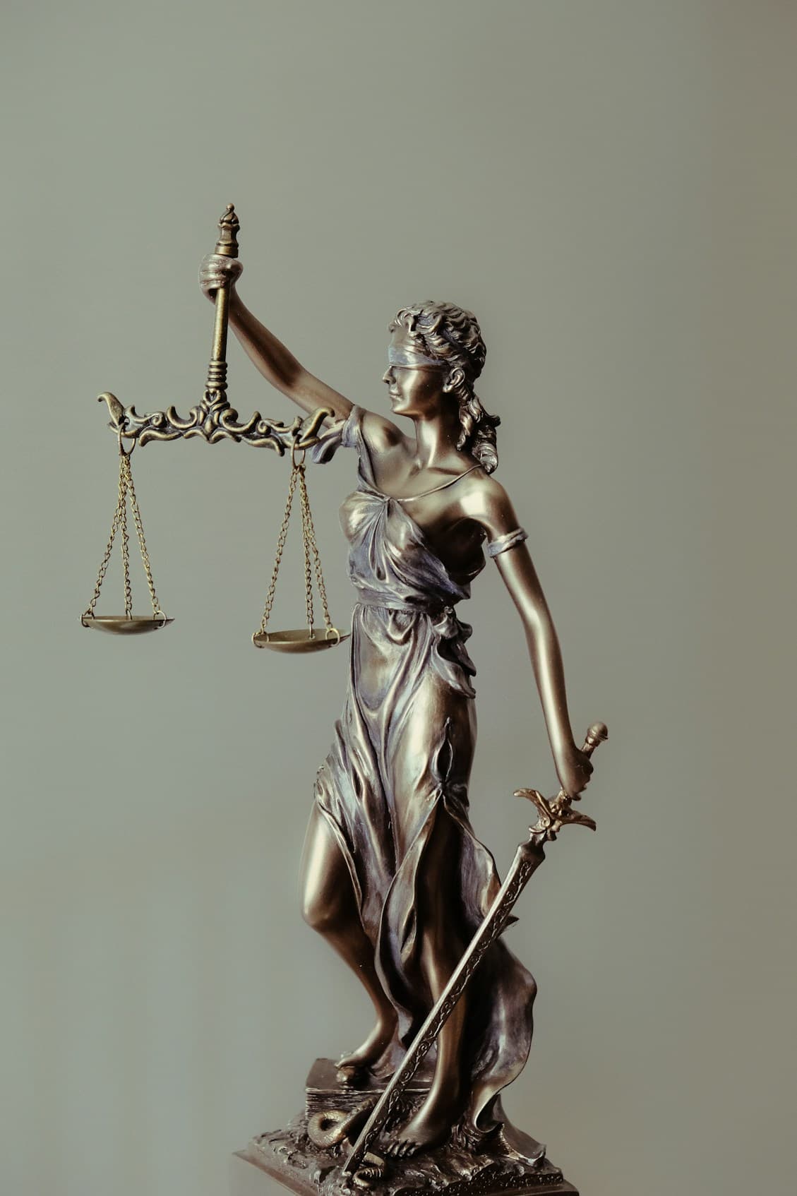 Bronze statue of Lady Justice holding scales and a sword